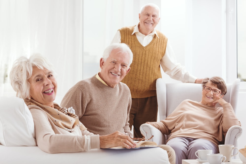 Four smiling seniors, indoors