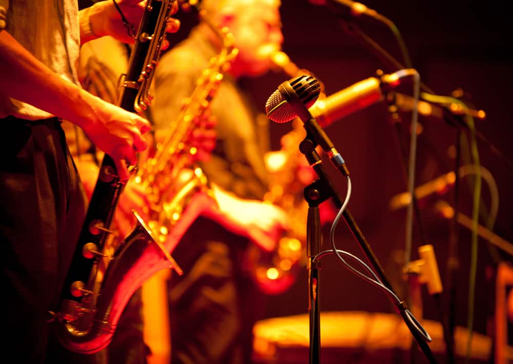 Close-up of men playing saxophones and microphone